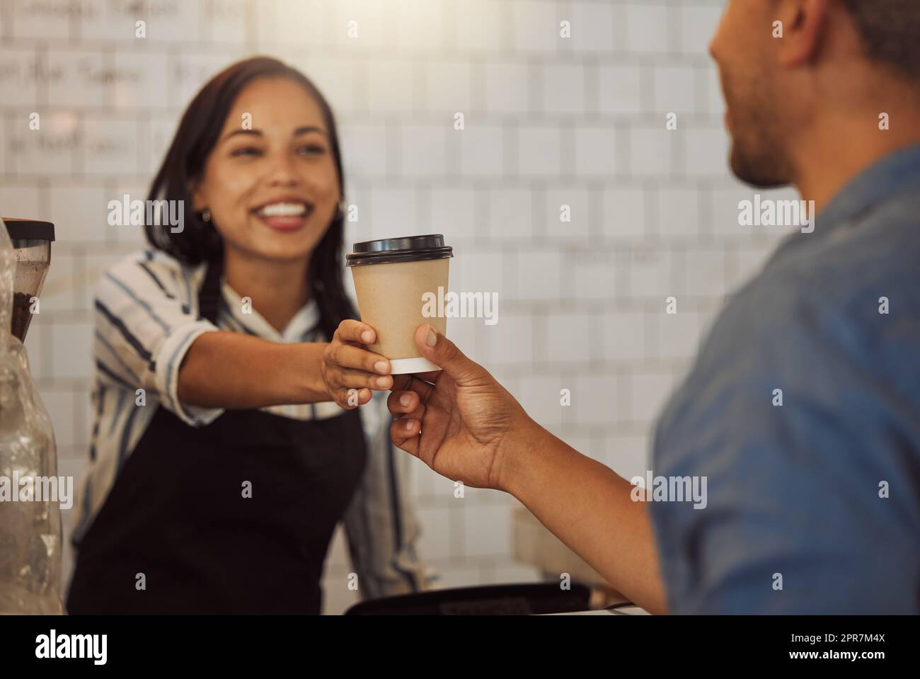 Barista giving a customer their cup of coffee. Customer collecting their coffeeshop order. Businesswoman giving a customer their order. Entrepreneur giving a customer a cup of tea Stock Photo