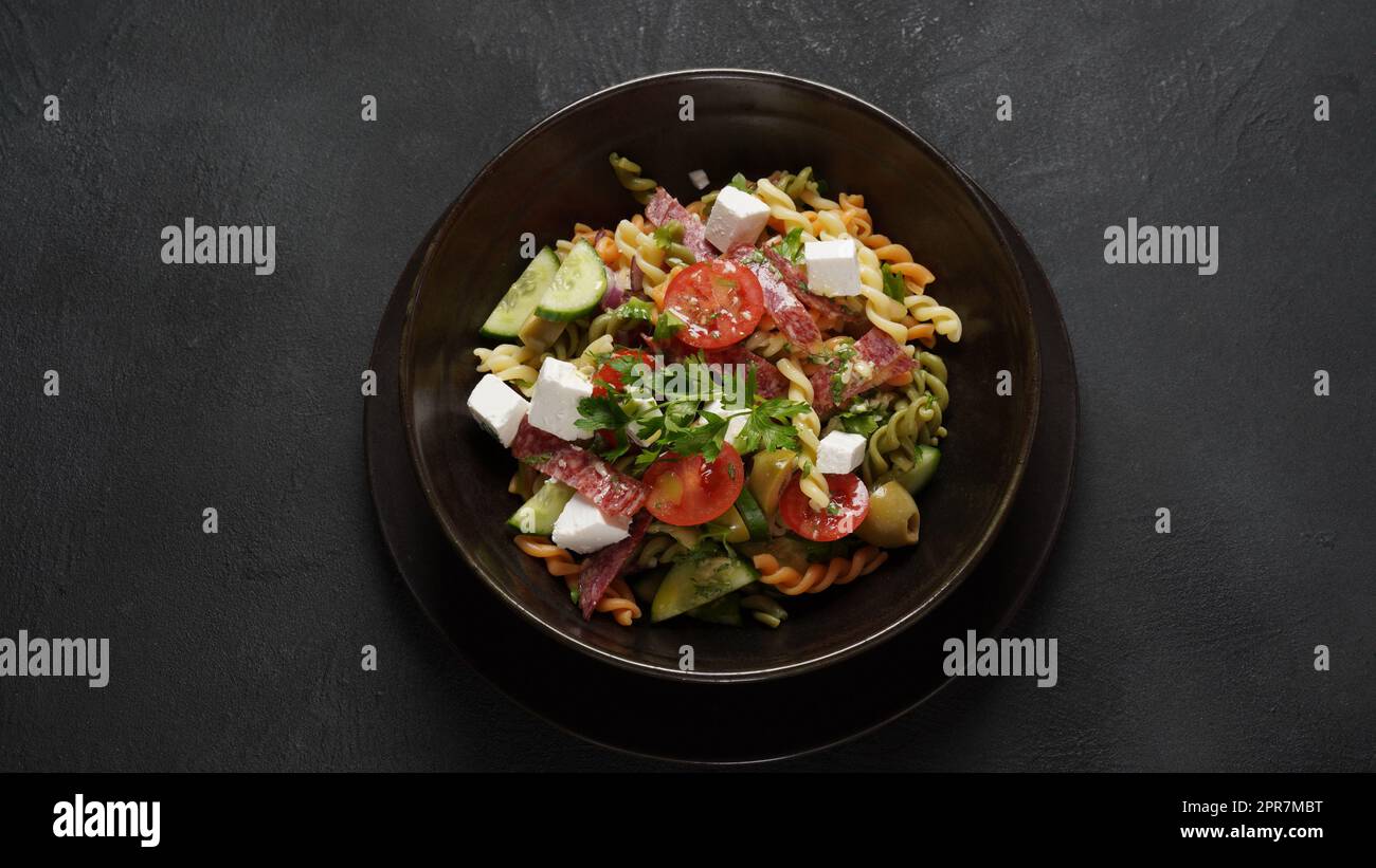 Italian pasta salad cucumbers, cherry tomatoes, olives, red onion