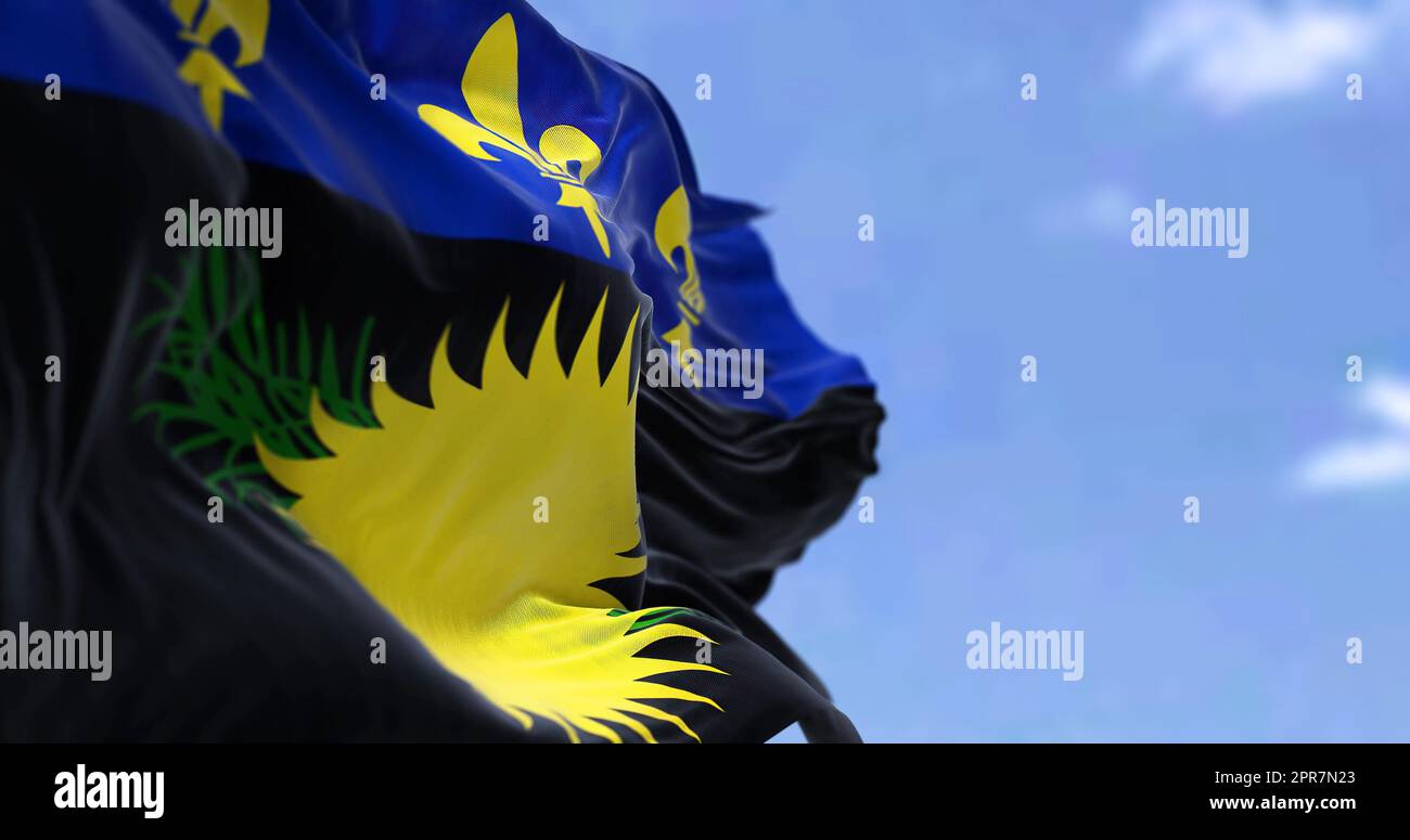 Flag of Guadeloupe waving in the wind on a clear day Stock Photo