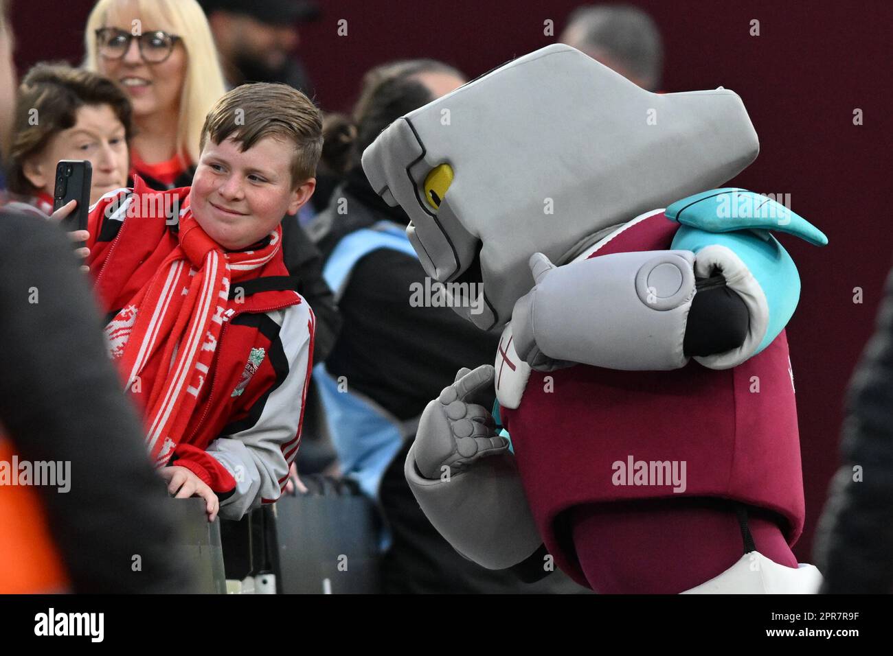 London, England on 26 April 2023. A young Liverpool FC supporter takes a selfie with the West Ham United mascot during the Premier League match between West Ham United and Liverpool at the London Stadium, Queen Elizabeth Olympic Park, London, England on 26 April 2023. Photo by Phil Hutchinson. Editorial use only, license required for commercial use. No use in betting, games or a single club/league/player publications. Credit: UK Sports Pics Ltd/Alamy Live News Stock Photo