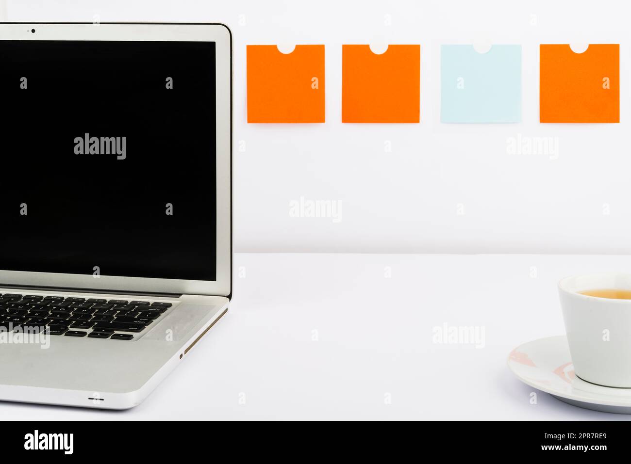 Important Messages On Lap Top On Desk With Notes And Cup Of Tea. Crutial Informations On Computer Screen On Table With Hot Drink. Critical Announcements Presented. Stock Photo