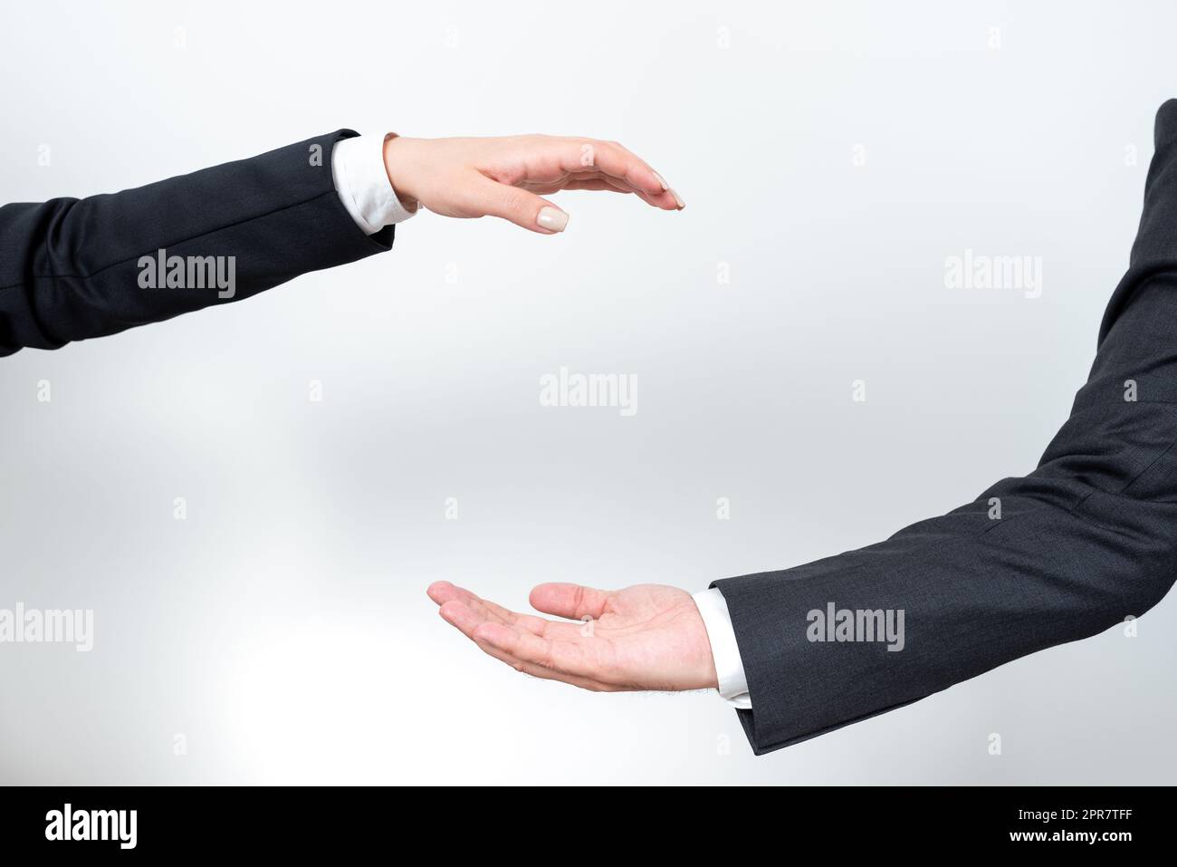 Important Message Presented Between Business Team Hands. Crutial Information Displayed Among Two Palms. Critical Announcements Shown From Man And Woman. Stock Photo