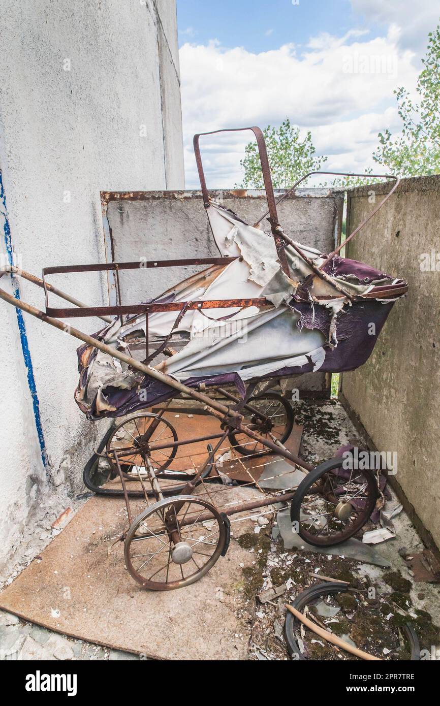 old baby carriage in abandoned house in Pripyat Ukraine Stock Photo