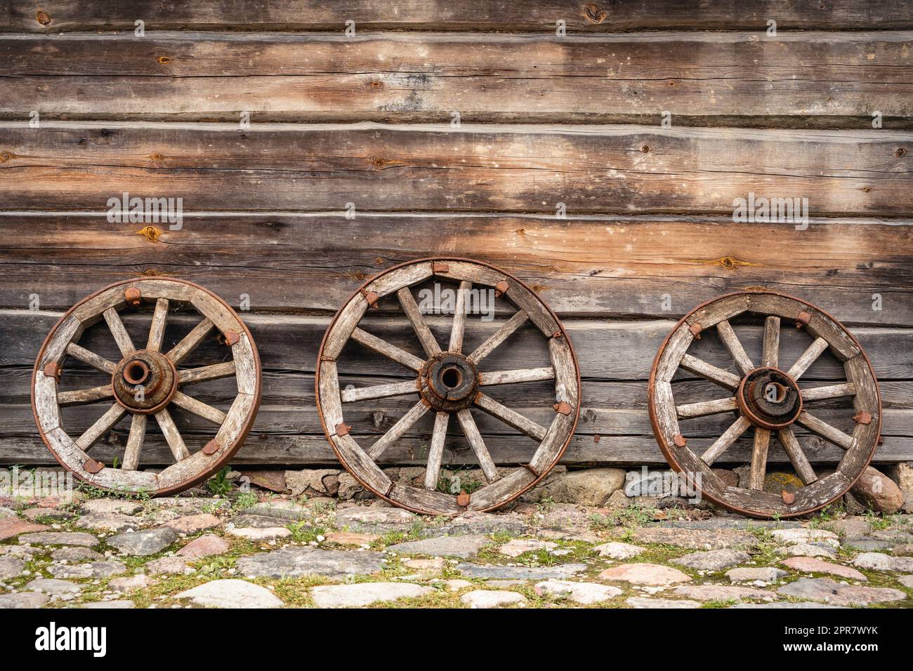 Three old wooden wagon wheels Stock Photo
