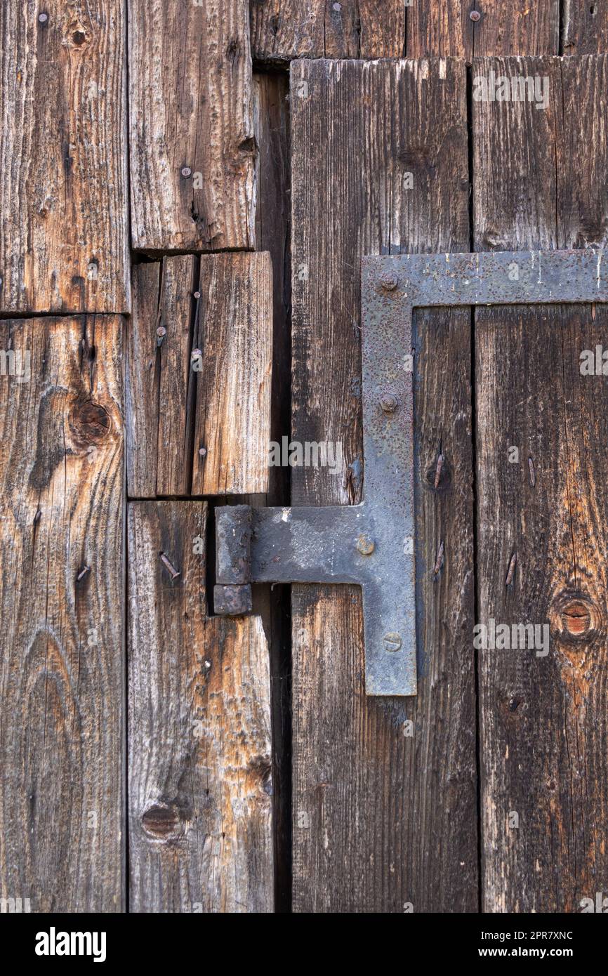 old door hinge at wooden barn Stock Photo