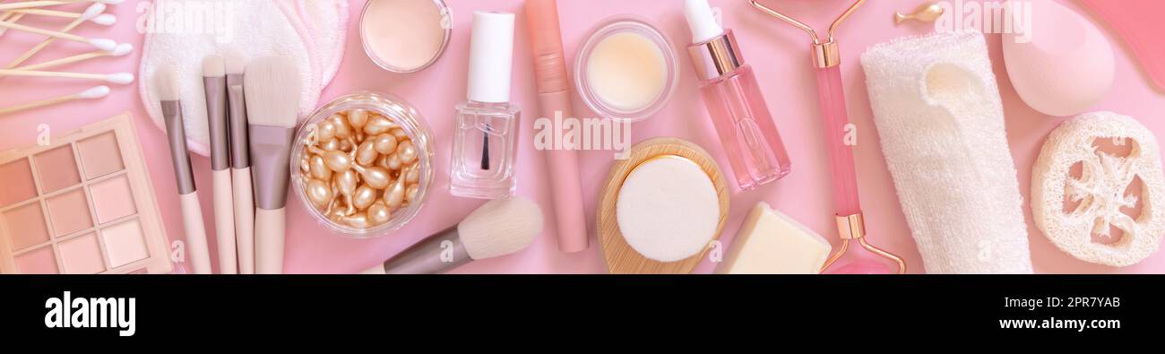 Natural skin care products and decorative cosmetics on light pink, top view Stock Photo