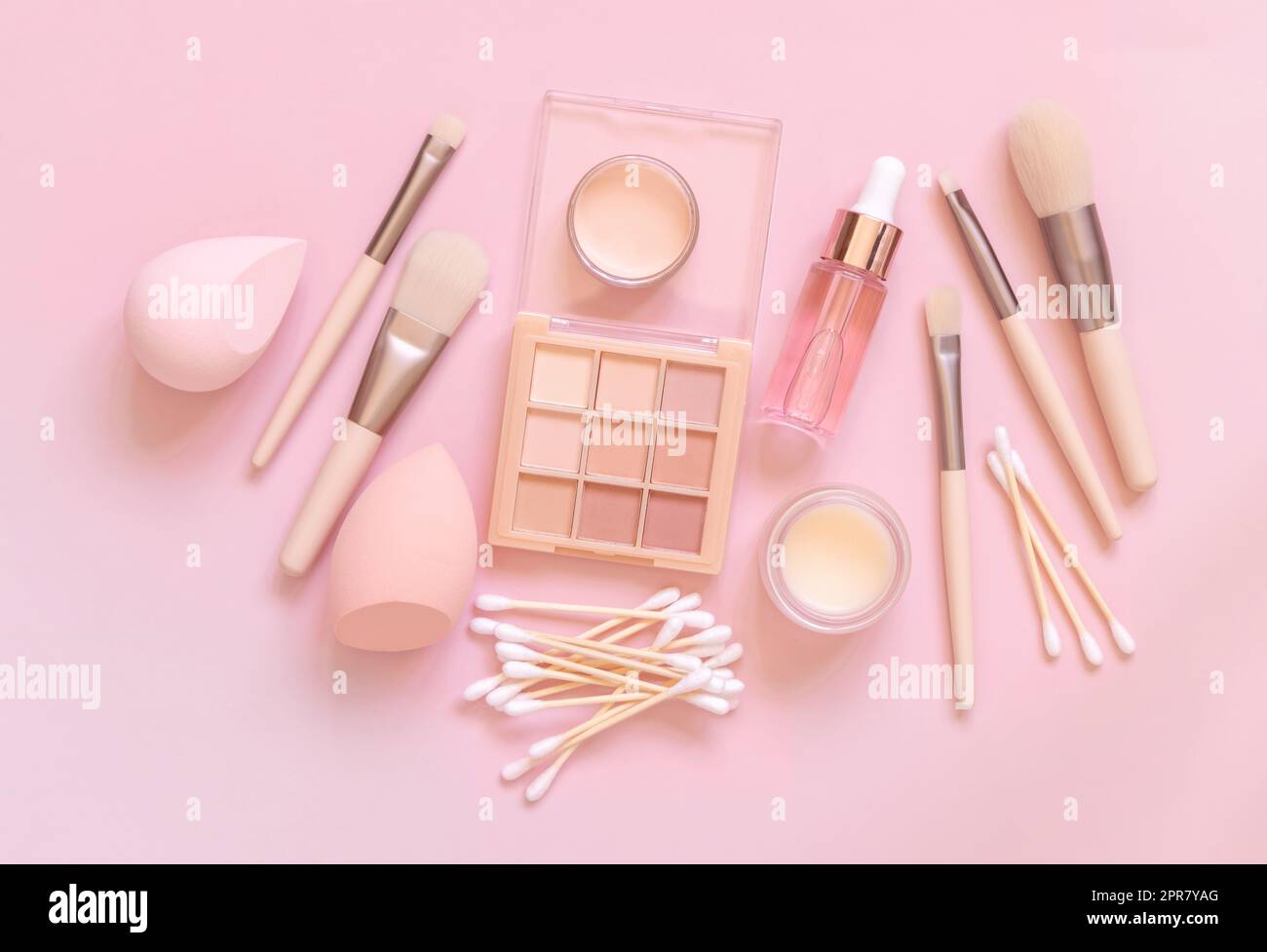 Natural beige eye shadow and decorative cosmetics on light pink, top view Stock Photo