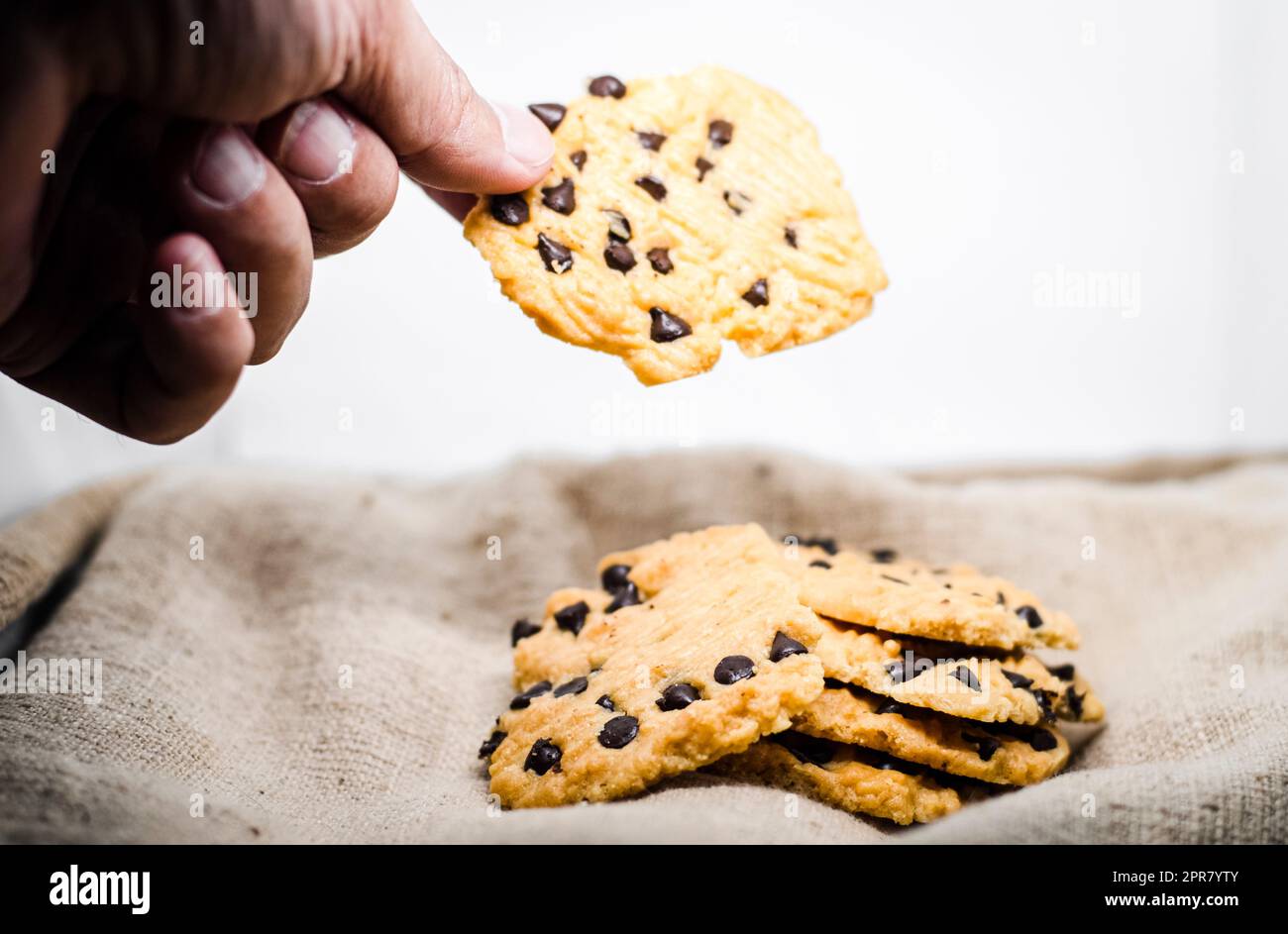 hand take a Chocolate Chip Cookie Bakery Cheesecake Baking sweet food snack object still life Stock Photo