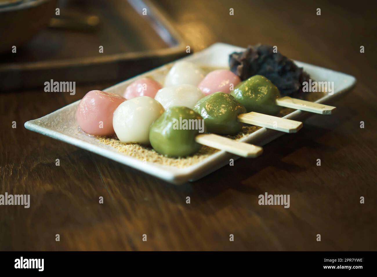 Three Color Japanese  Hanami Dango Dumpling sweet dessert on white ceramic plate. Stock Photo