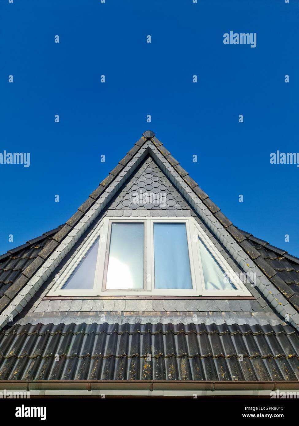 Open roof window in velux style with black roof tiles Stock Photo - Alamy