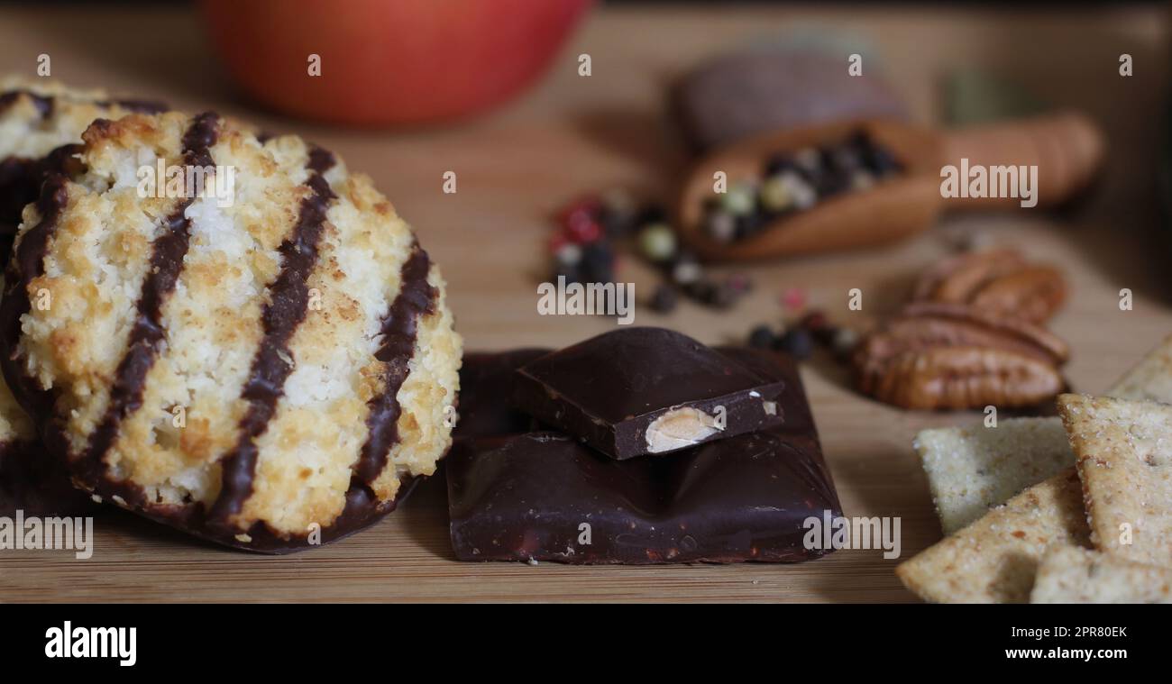 Coconut Macaroon With Belgian Chocolate With Nuts and Spices in Background Stock Photo