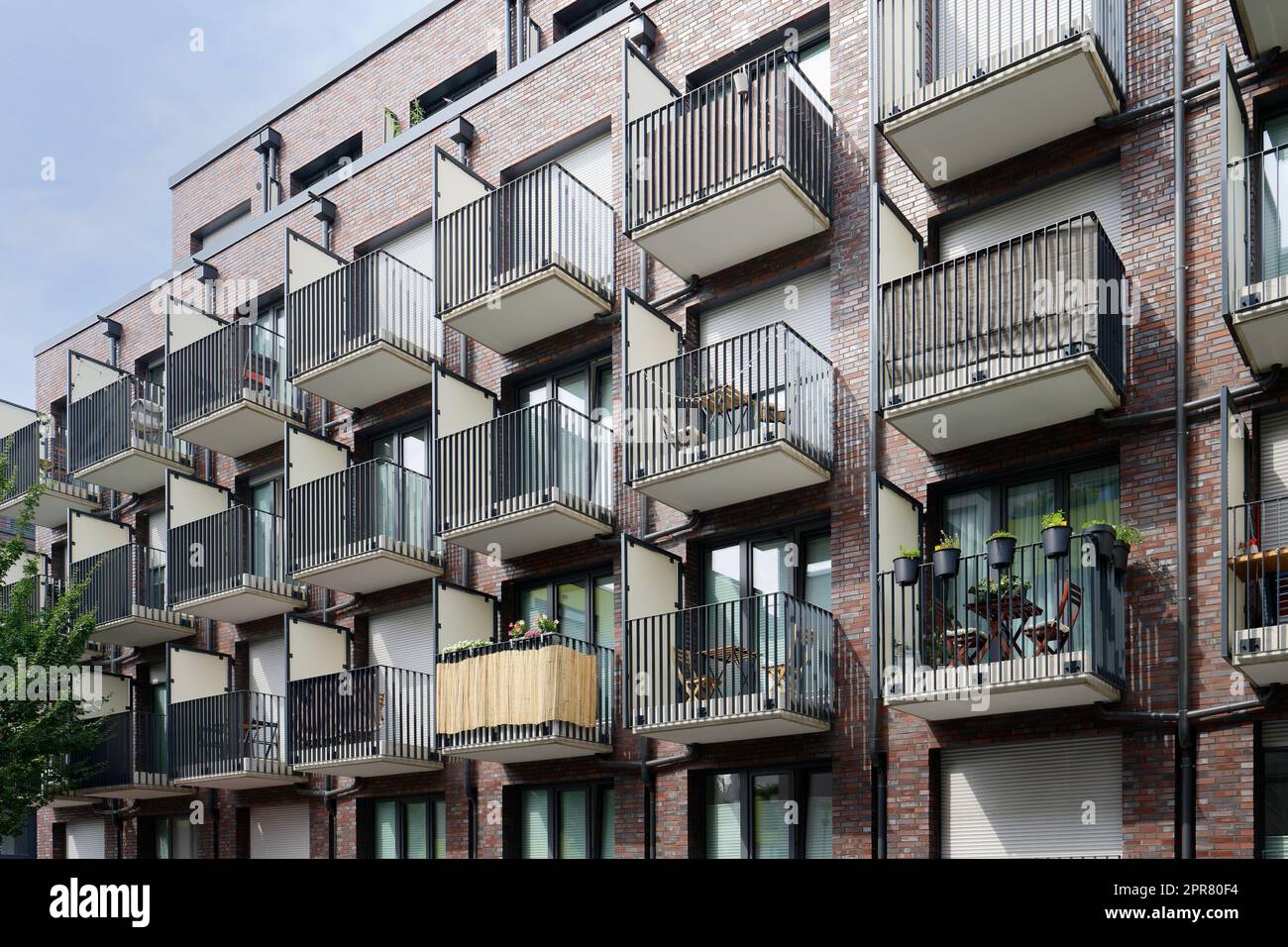many small balconies with tables, chairs and decoration at a student residence in cologne Stock Photo