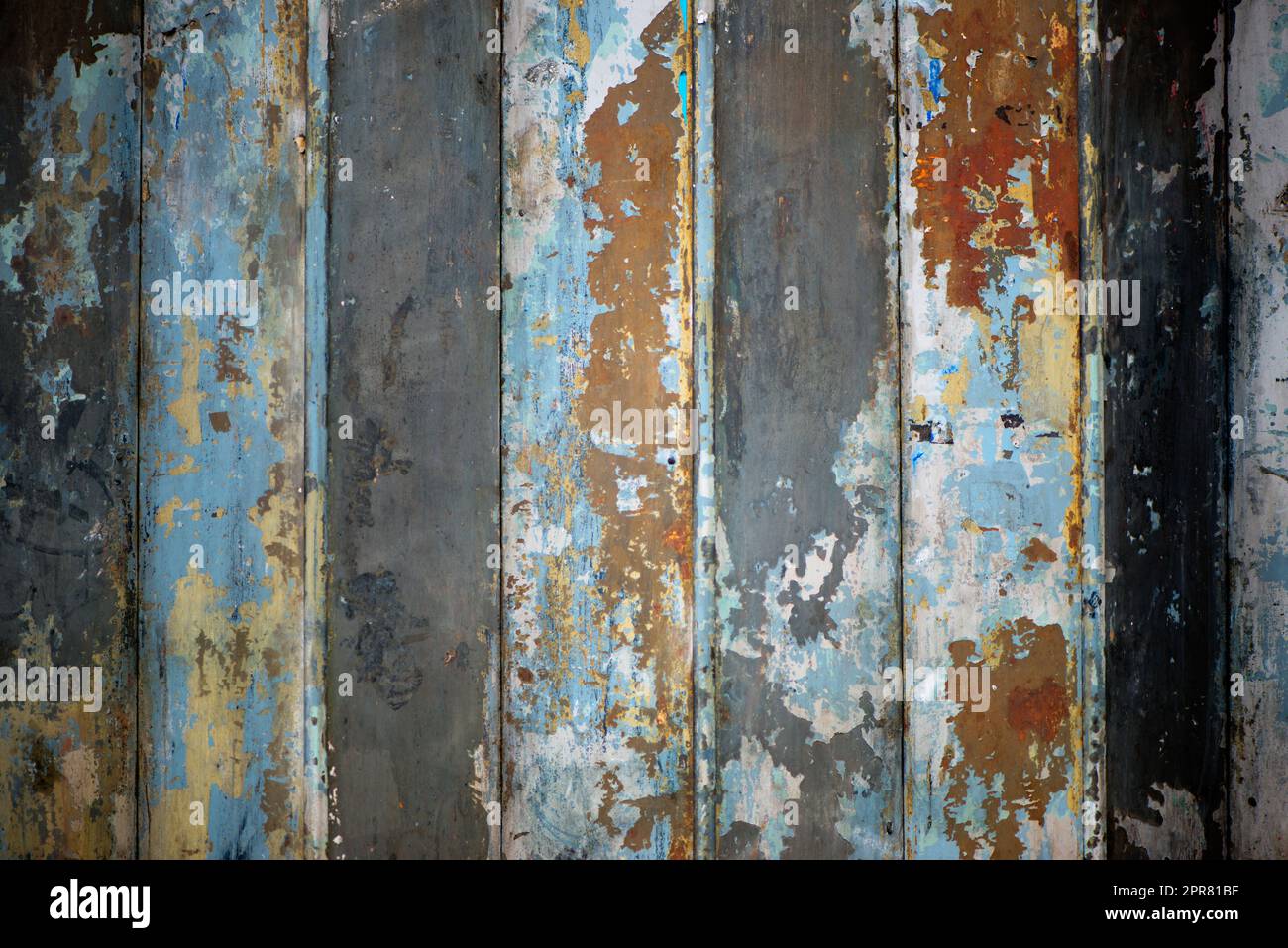 Not everything decaying is ugly. bright blue paint peeling off a rusty