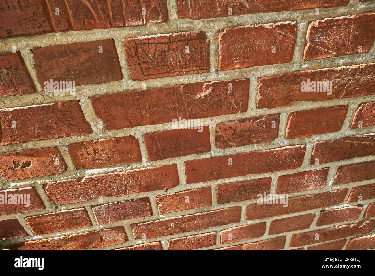 Closeup of weathered red brick wall and copy space on exterior of a home, house or city building. Texture, detail background, perspective of rough architecture or construction design on old structure Stock Photo
