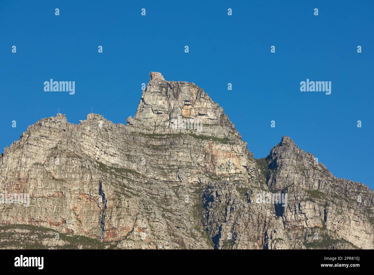 Landscape view of Table Mountain in Cape Town, South Africa with blue sky and copy space. Low angle of a steep, rough and rugged famous hiking terrain. Risky and dangerous challenge to climb the peak Stock Photo