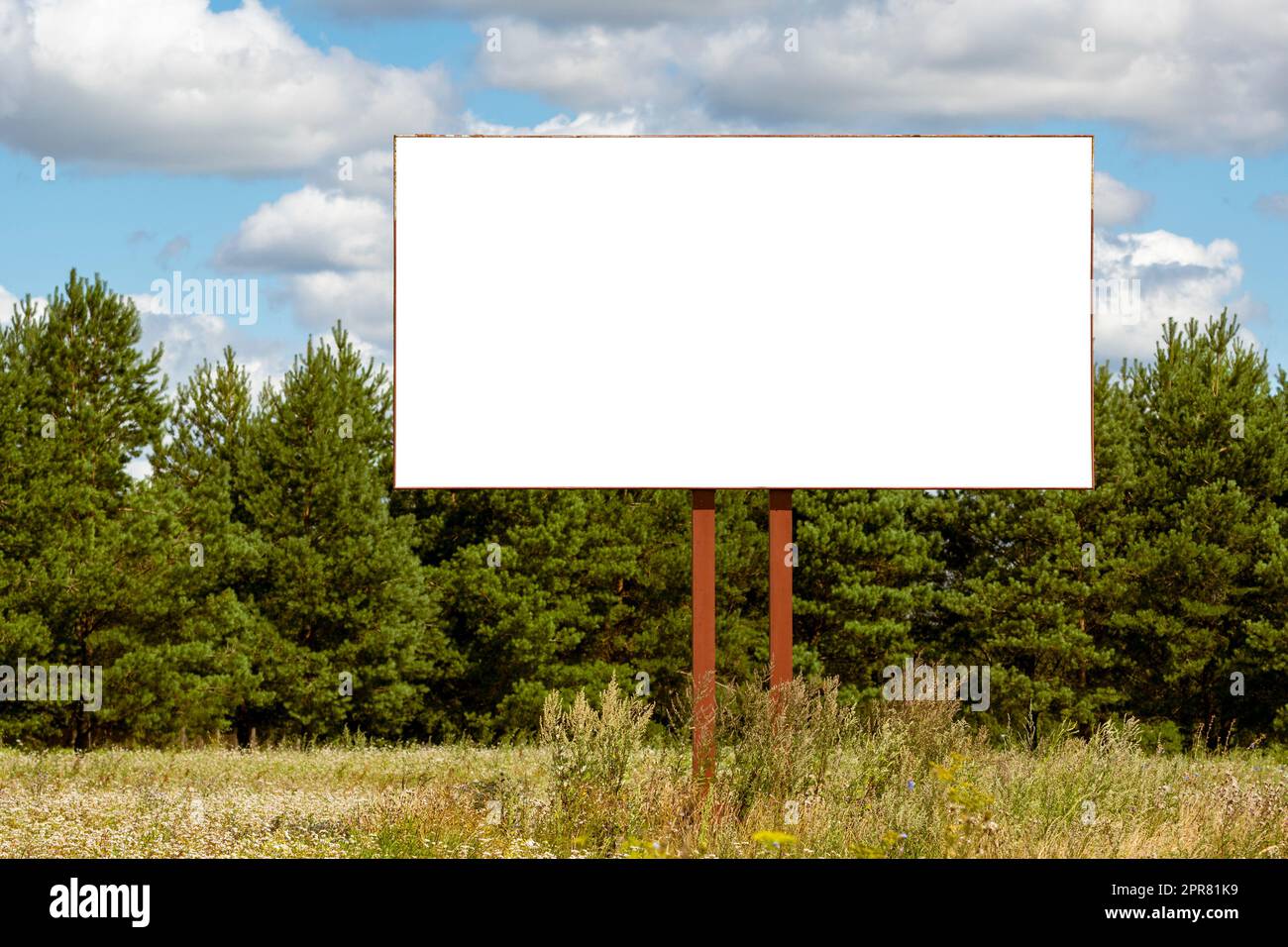 A blank advertising billboard in a grass field Stock Photo