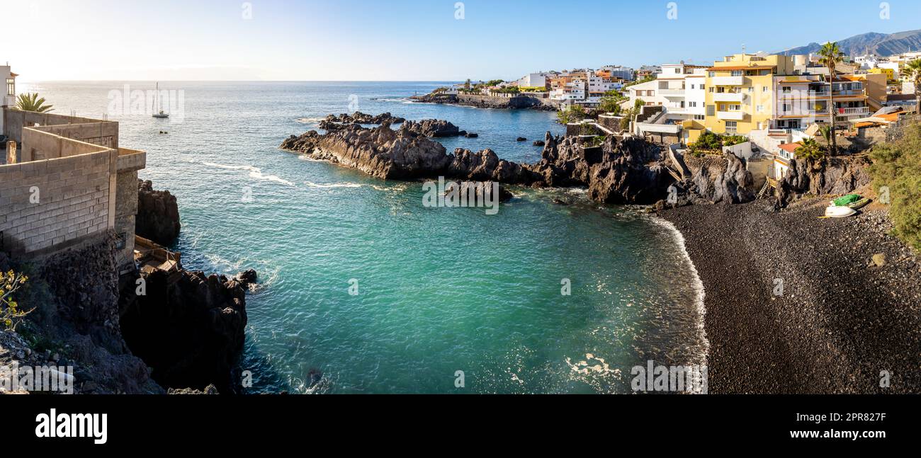 Breathtaking panoramic view of the idyllic bay in Tenerife's fishing village of Alcalá, where the waters of the Atlantic Ocean wash against the coast. Stock Photo