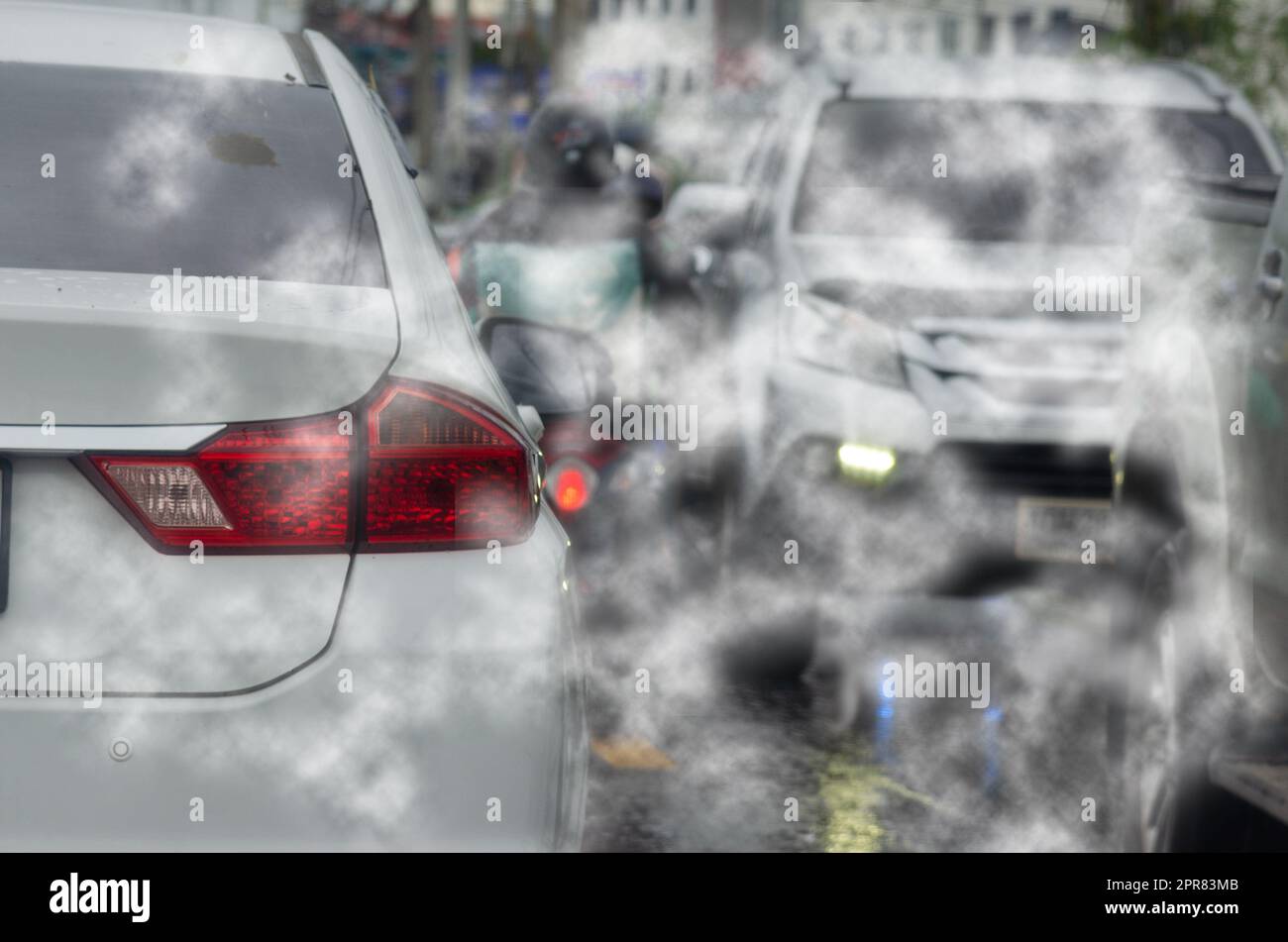 car pollution smoke exhaust automobile pollution traffic jam on road.Car emitting carbon dioxide causing air pollution. Stock Photo