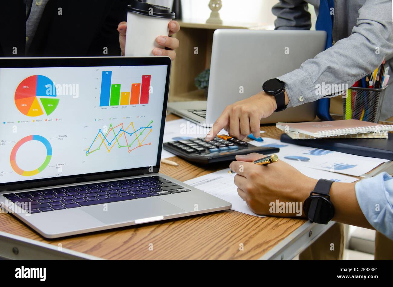 Business people meeting at the office by analyzing data from financial graphs and investment charts to plan a marketing team. Stock Photo