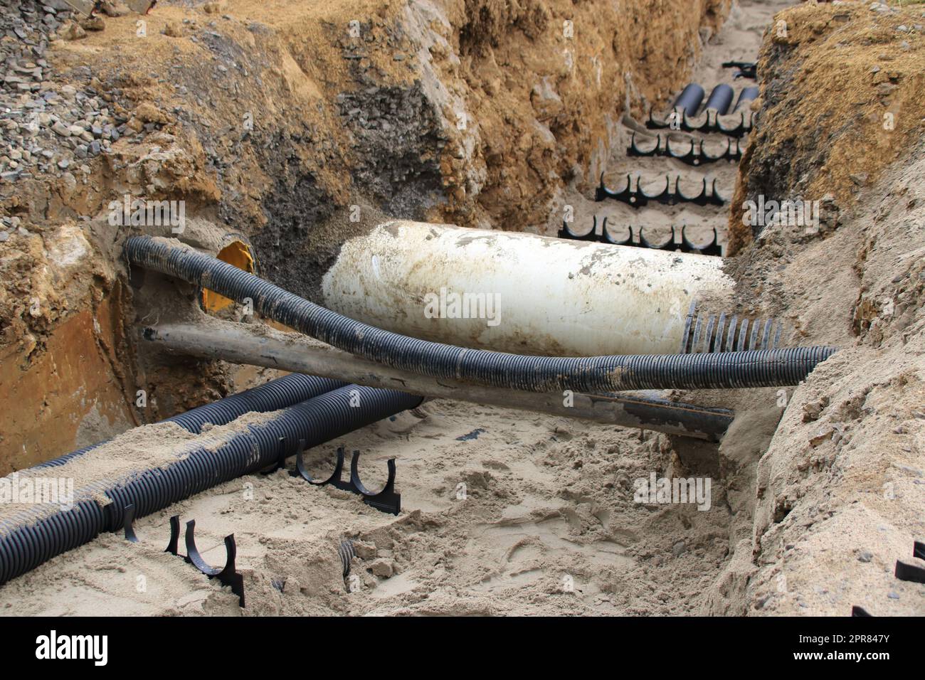 Empty conduits for cables lie in a trench Stock Photo Alamy