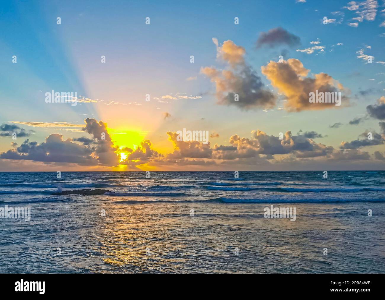Golden colorful sunrise sunset with sunbeams tropical beach Tulum ...