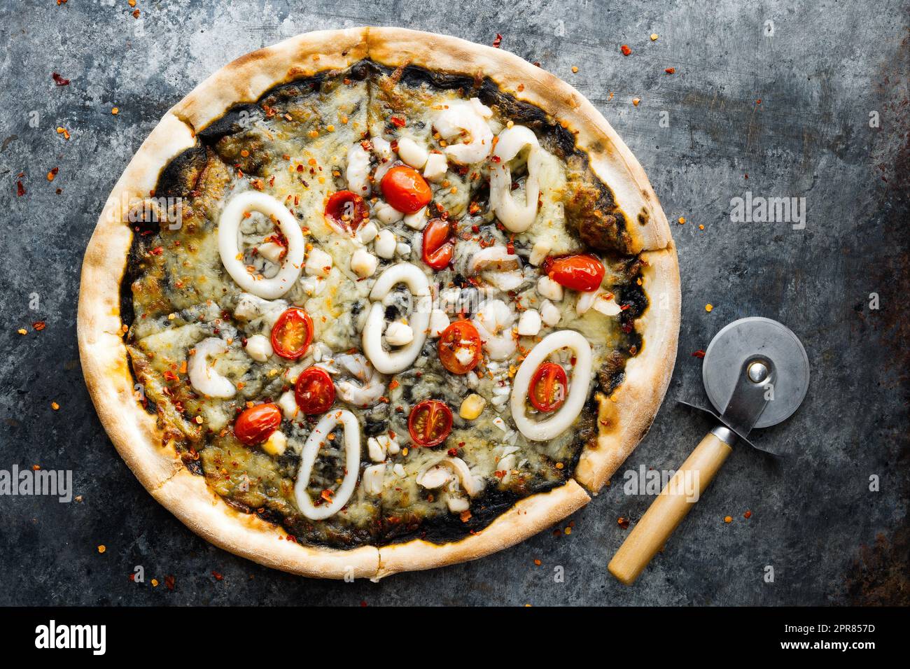 rustic italian squid ink black seafood pizza Stock Photo