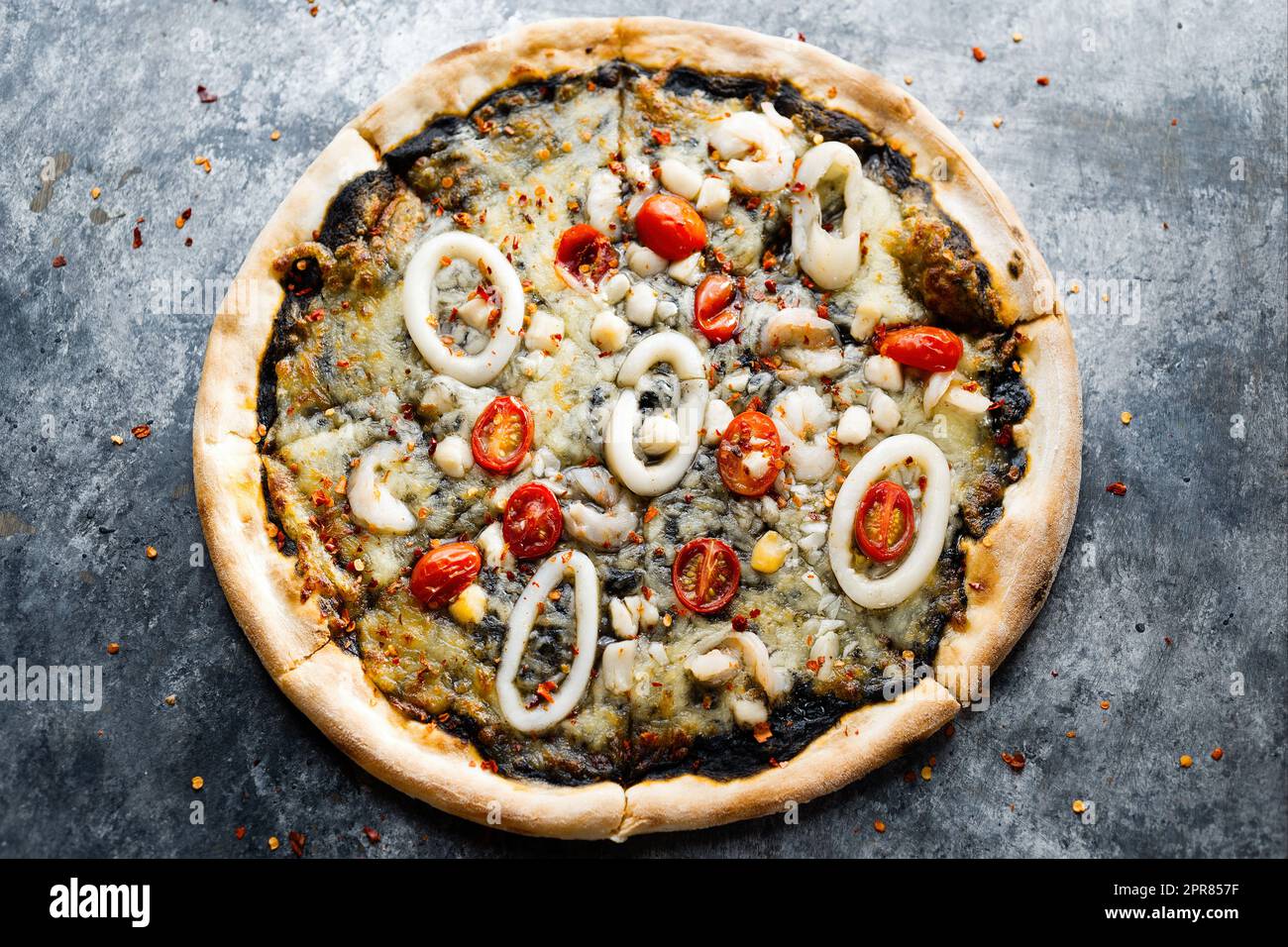 rustic italian squid ink black seafood pizza Stock Photo