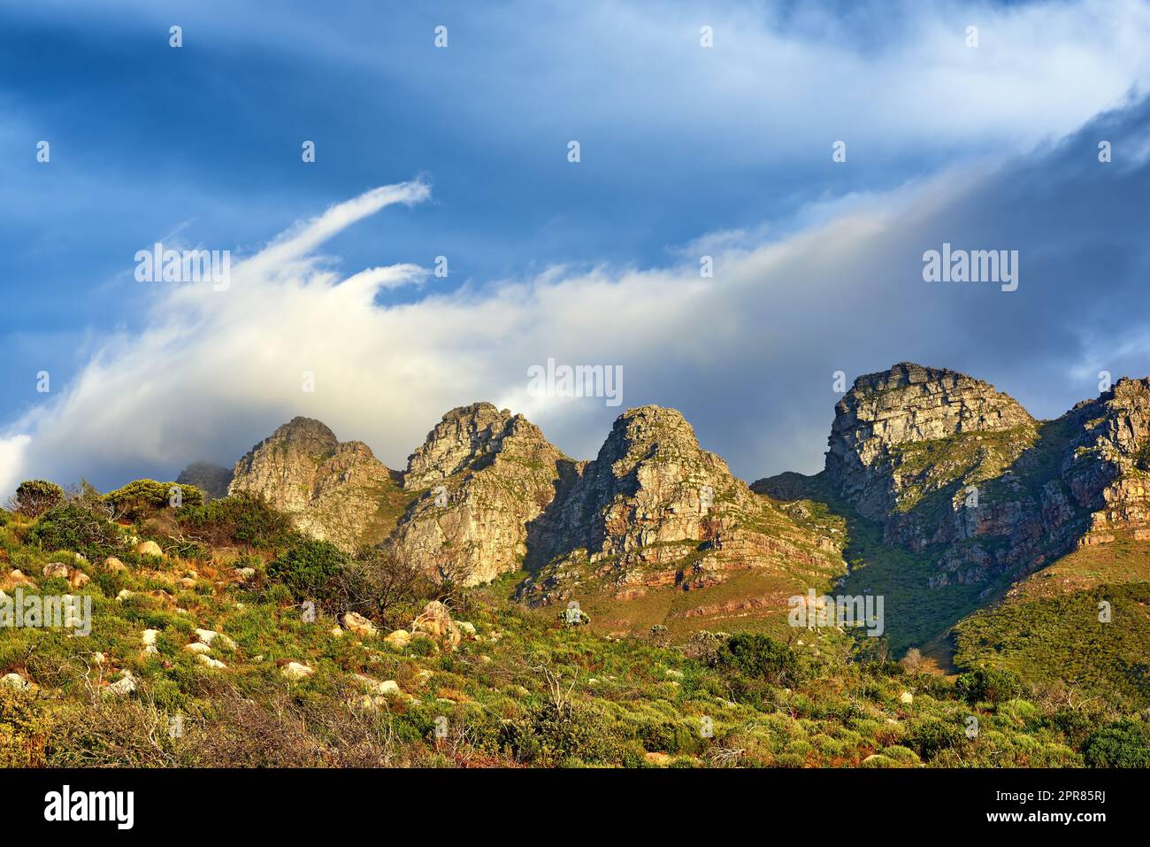 Landscape view of mountains and blue sky in Cape Town, South Africa during summer holiday and vacation. Scenic hills of fresh green flora growing in remote area. Exploring mother nature and the wild Stock Photo