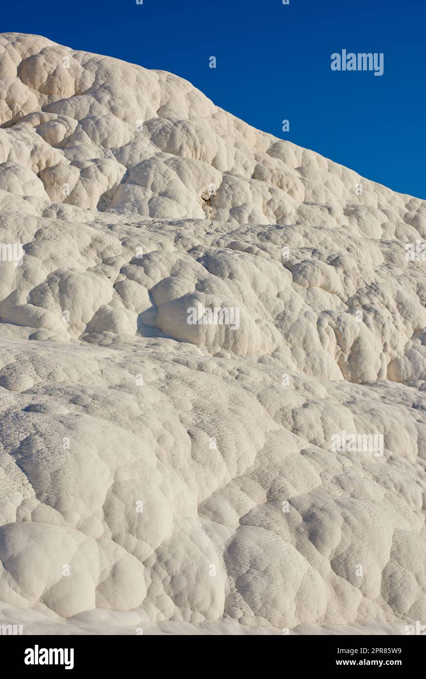 Closeup of travertine pools and terrace rock in Pamukkale, Turkey in famous tourism holiday or vacation destination. Cotton castle area with carbonate mineral after flowing thermal spring water Stock Photo