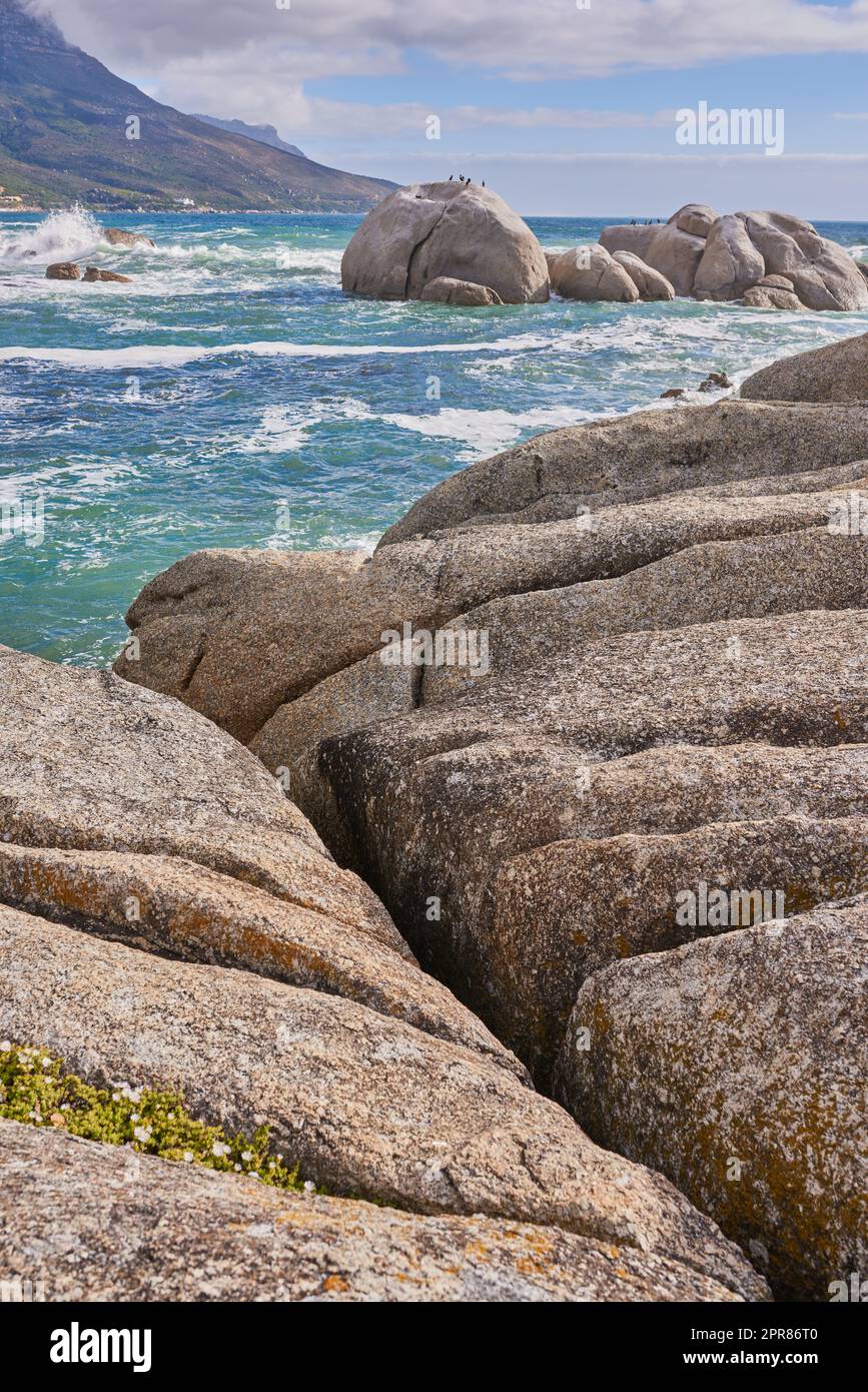 Rocky coastline of the Camps Bay, Western Cape. Ocean view - Camps Bay, Table Mountain National Park, Cape Town, South Africa. Stock Photo