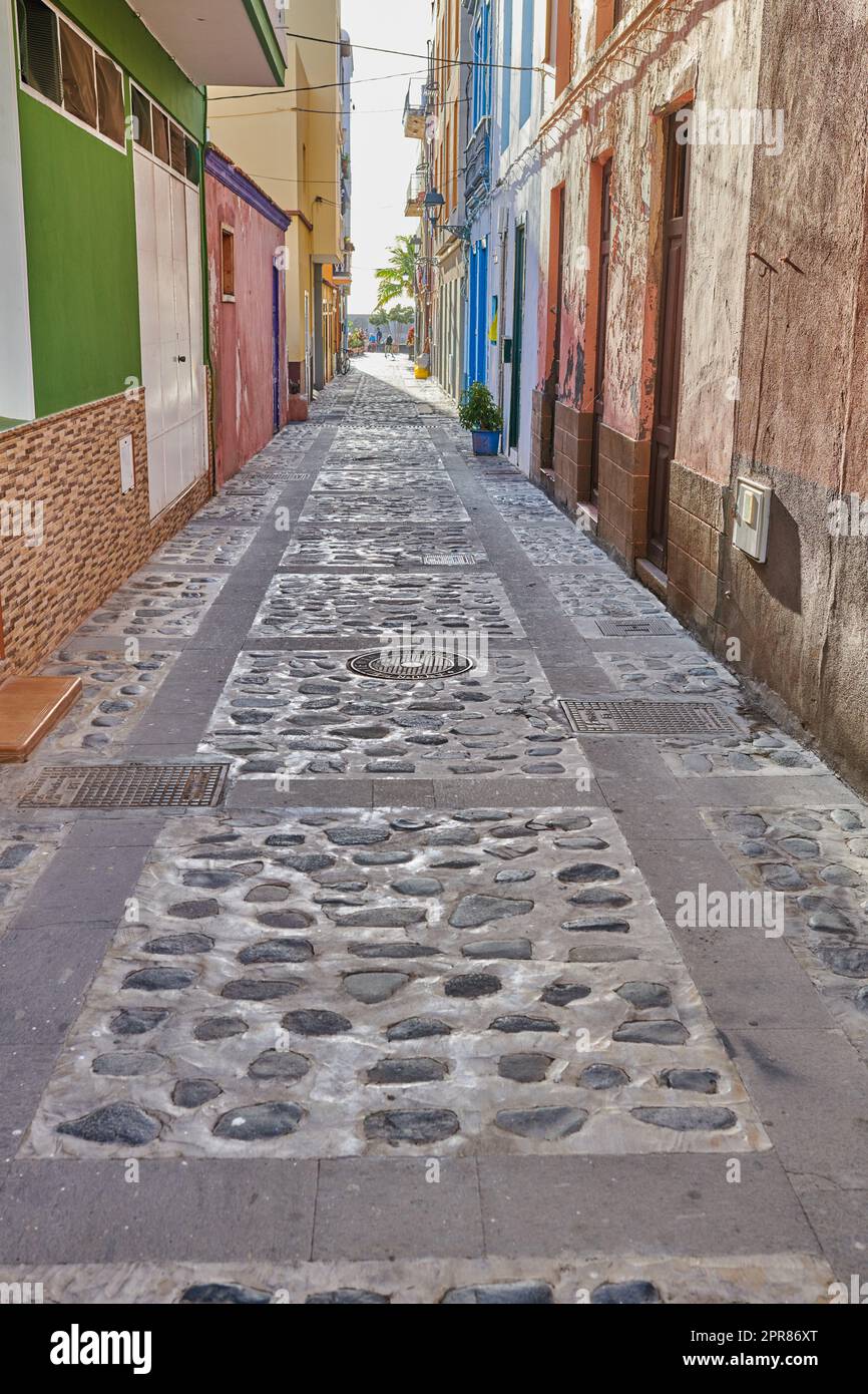 City street view of residential houses or buildings in leading alleyway in Santa Cruz, La Palma, Spain. Historical spanish and colonial architecture in tropical village and famous tourism destination Stock Photo