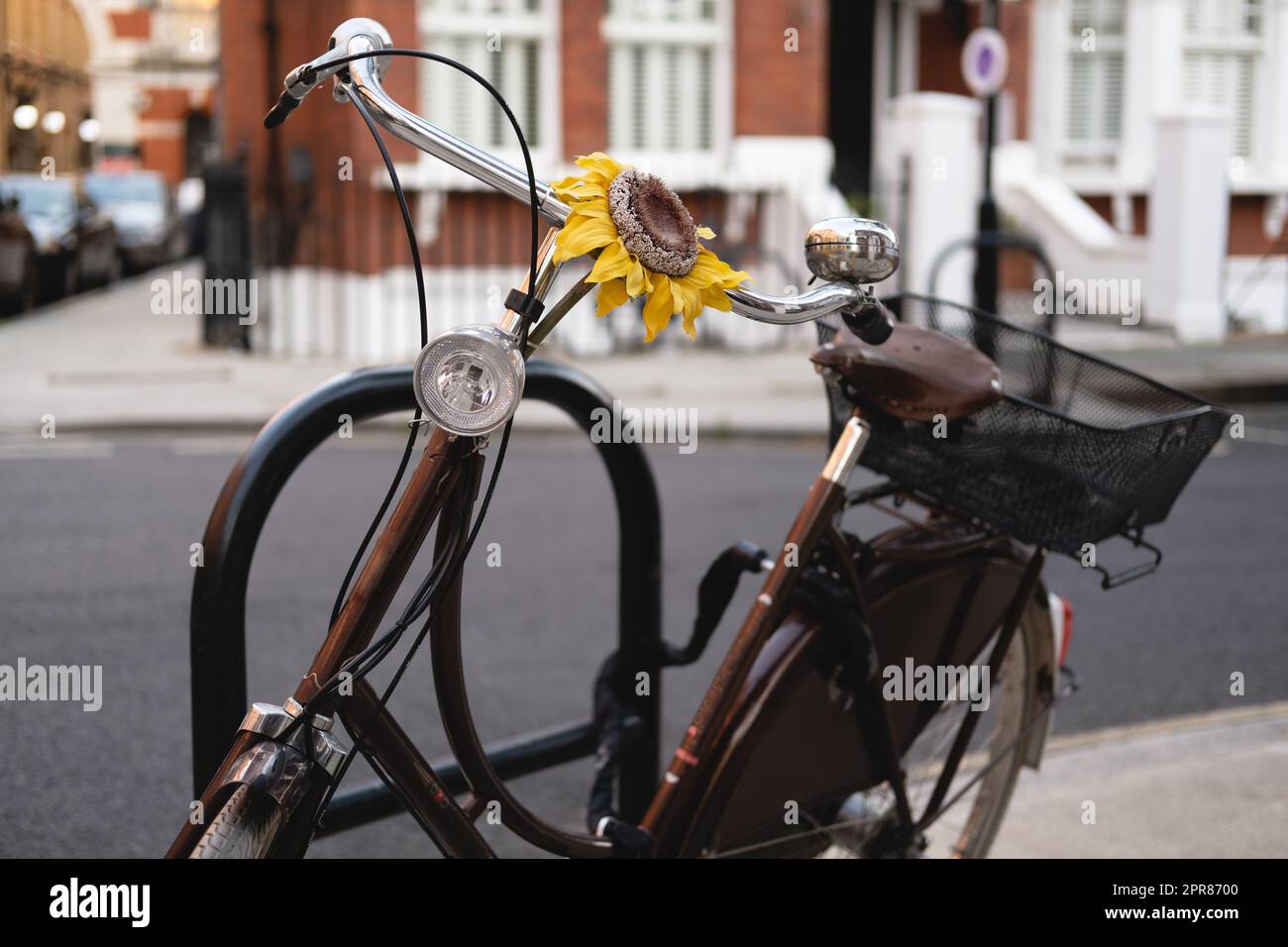 Horizontal closeup of brown vintage look bicycle with a yellow