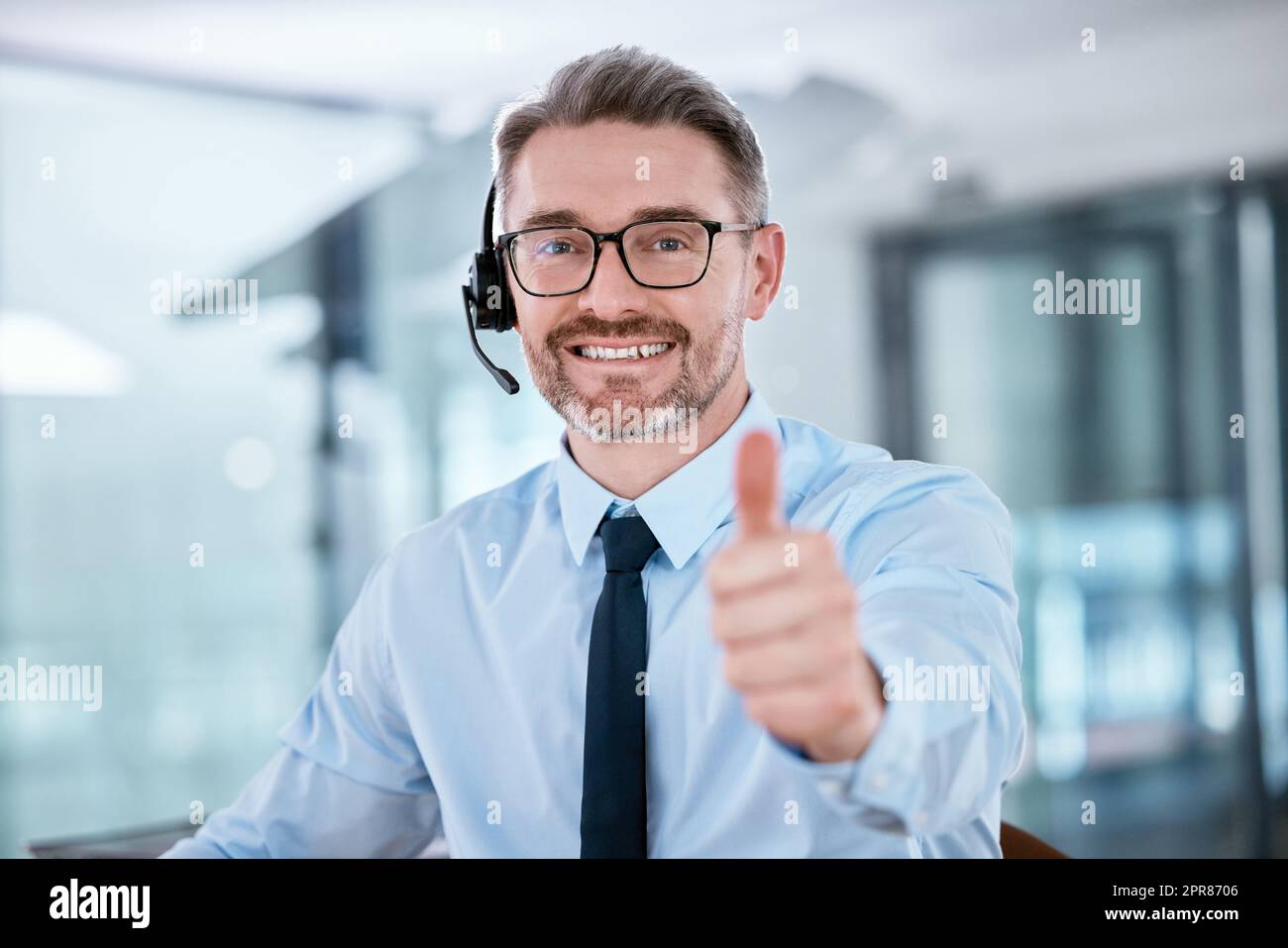 Im so thrilled to have reached my target. Portrait of a mature call centre agent showing thumbs up in an office. Stock Photo