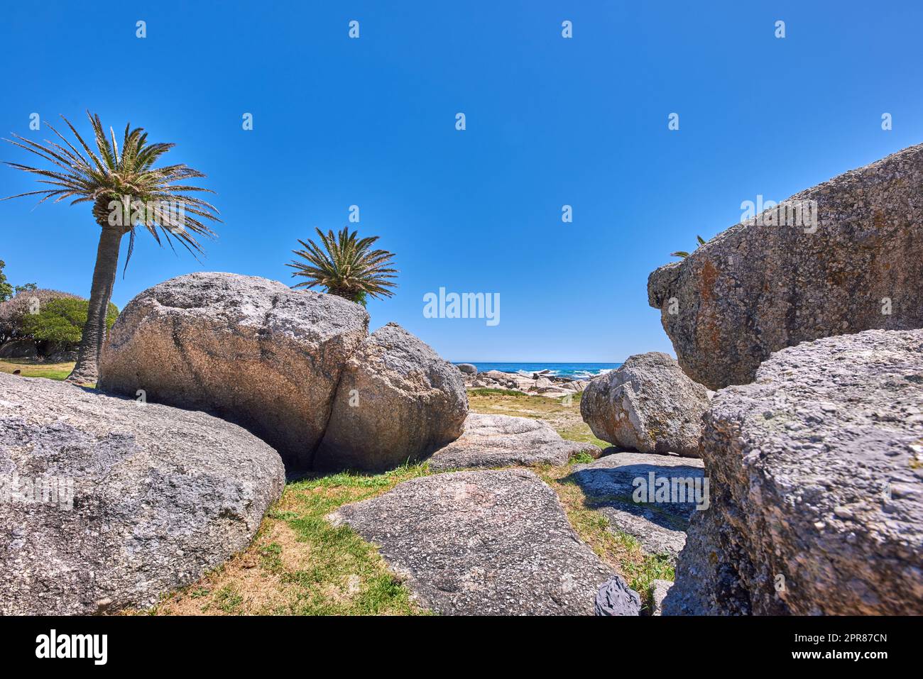 Rocky coastline of the Camps Bay, Western Cape. Ocean view - Camps Bay, Table Mountain National Park, Cape Town, South Africa. Stock Photo