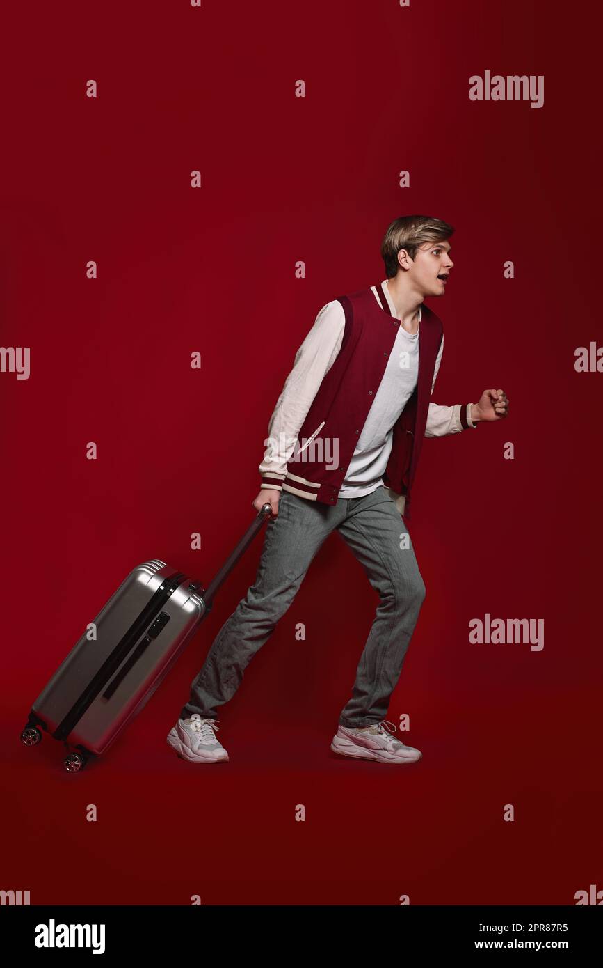 Young excited caucasian man tourist with suitcase Stock Photo