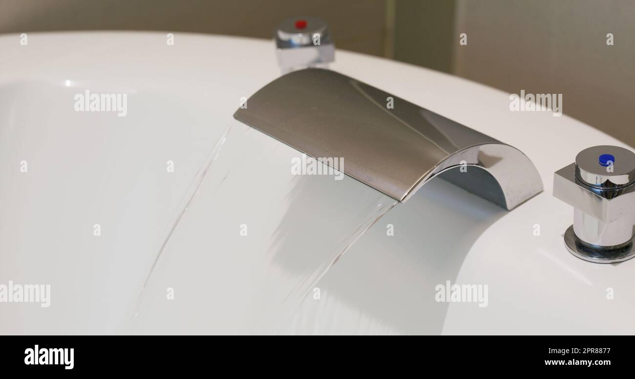 Water coming out from tap for the bathtub Stock Photo - Alamy