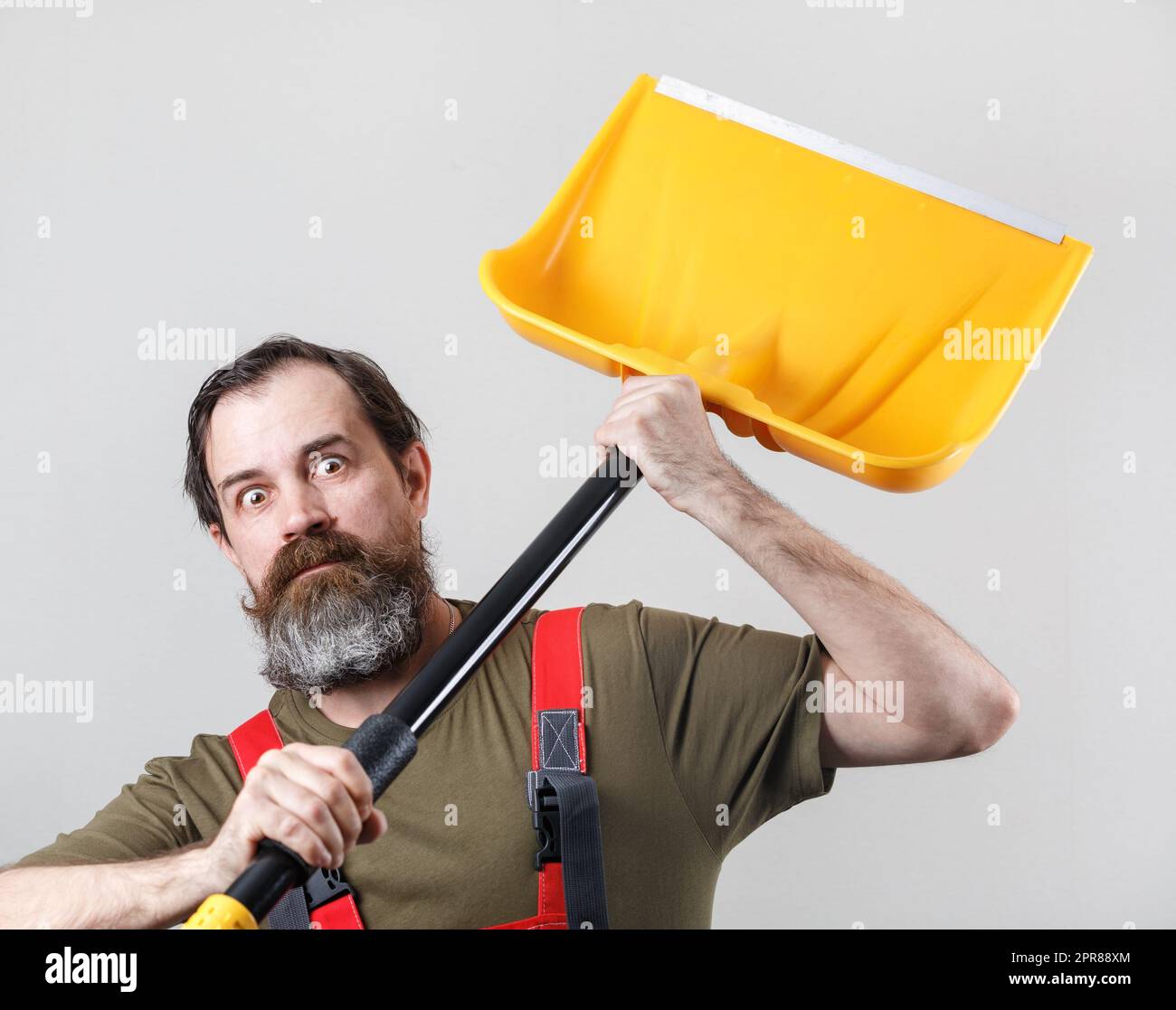 Crazy man, snow shovel Stock Photo