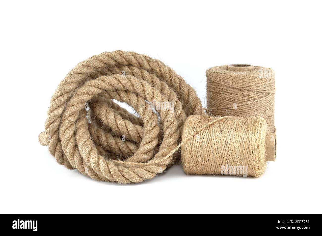 Twisted jute rope and spools of burlap threads or twine Stock Photo Alamy