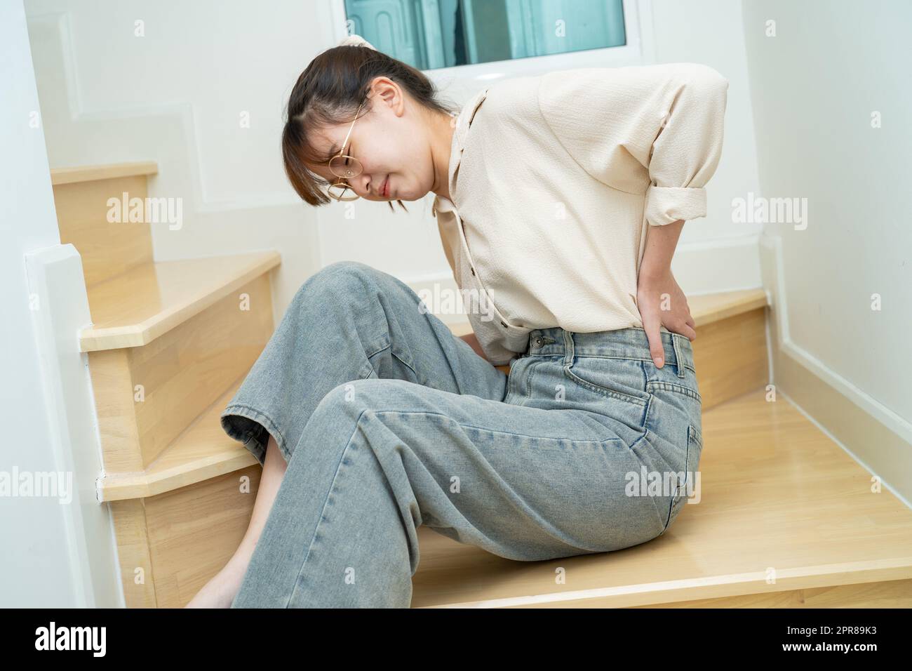 Asian lady woman patient fall down the stairs because slippery surfaces Stock Photo