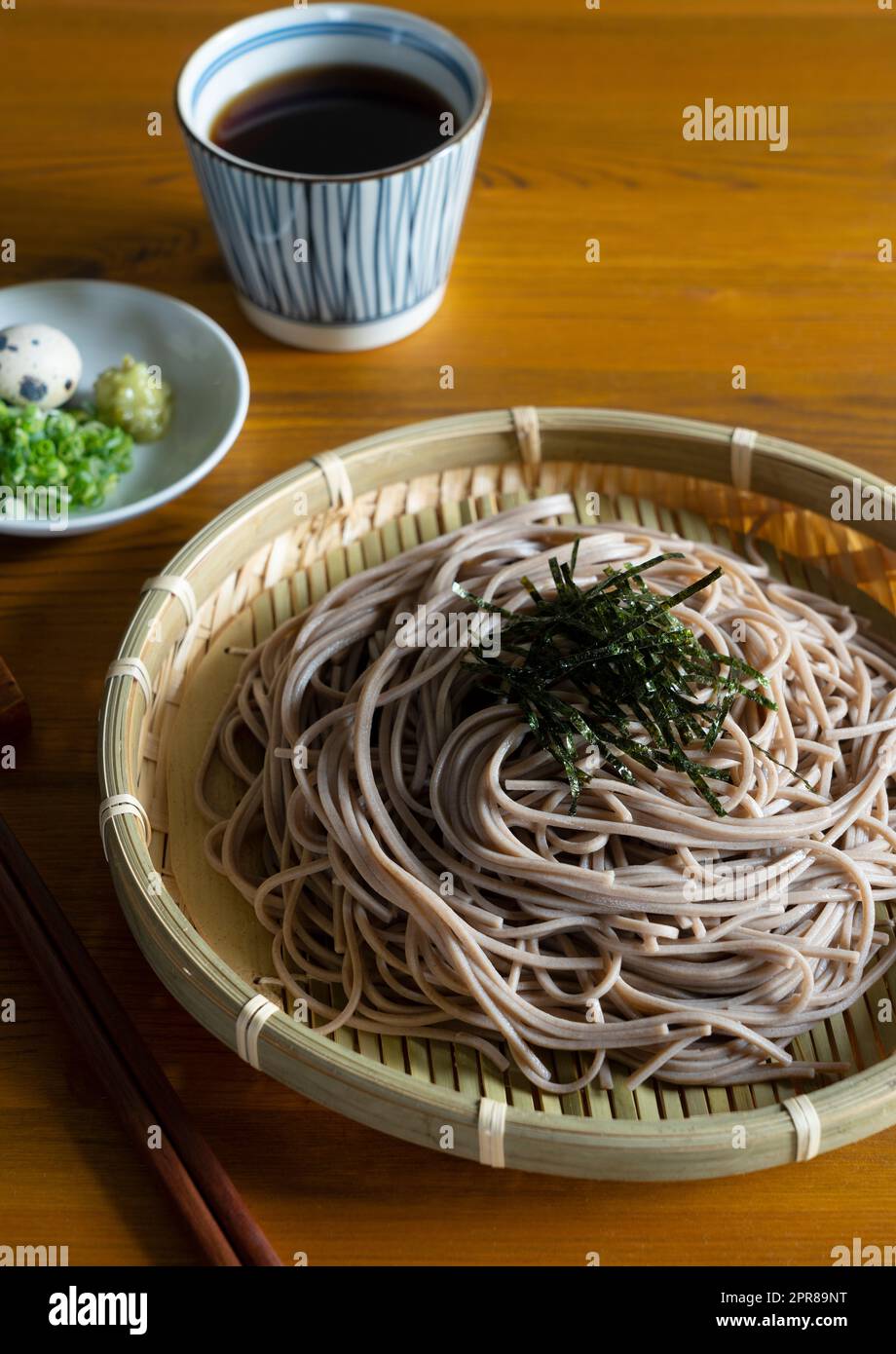 Zaru-soba and condiments on a wooden table. Stock Photo