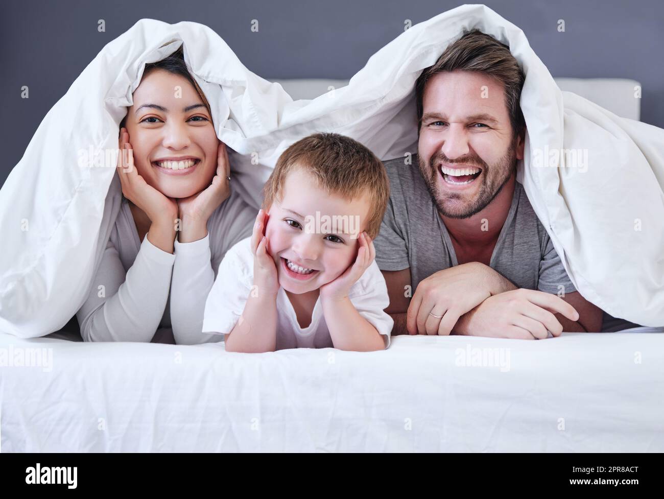 He always steals the show. Shot of a young family relaxing at home. Stock Photo