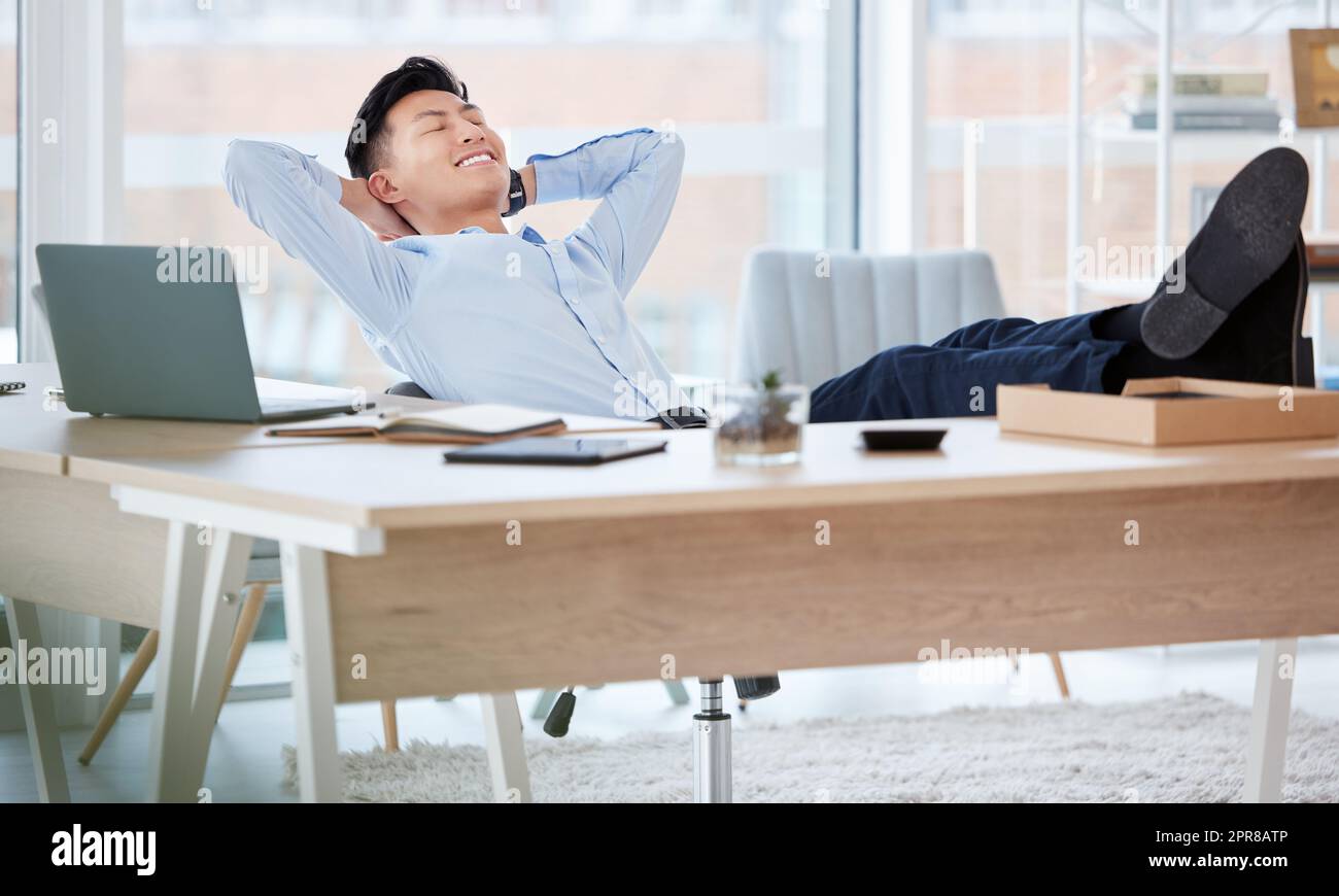 This is what Ive always dreamed of. Shot of a young businessman sleeping at his desk in an office. Stock Photo