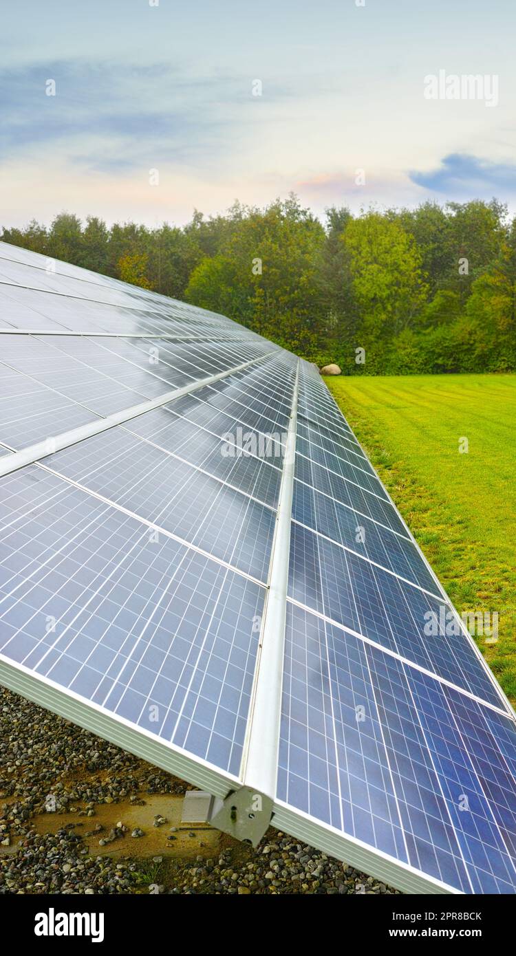 Solar power renewable source in Denmark. Photovoltaic solar cell panels as a natural energy source. Blue solar panels generate electricity in solar power technology, alternative energy from nature Stock Photo