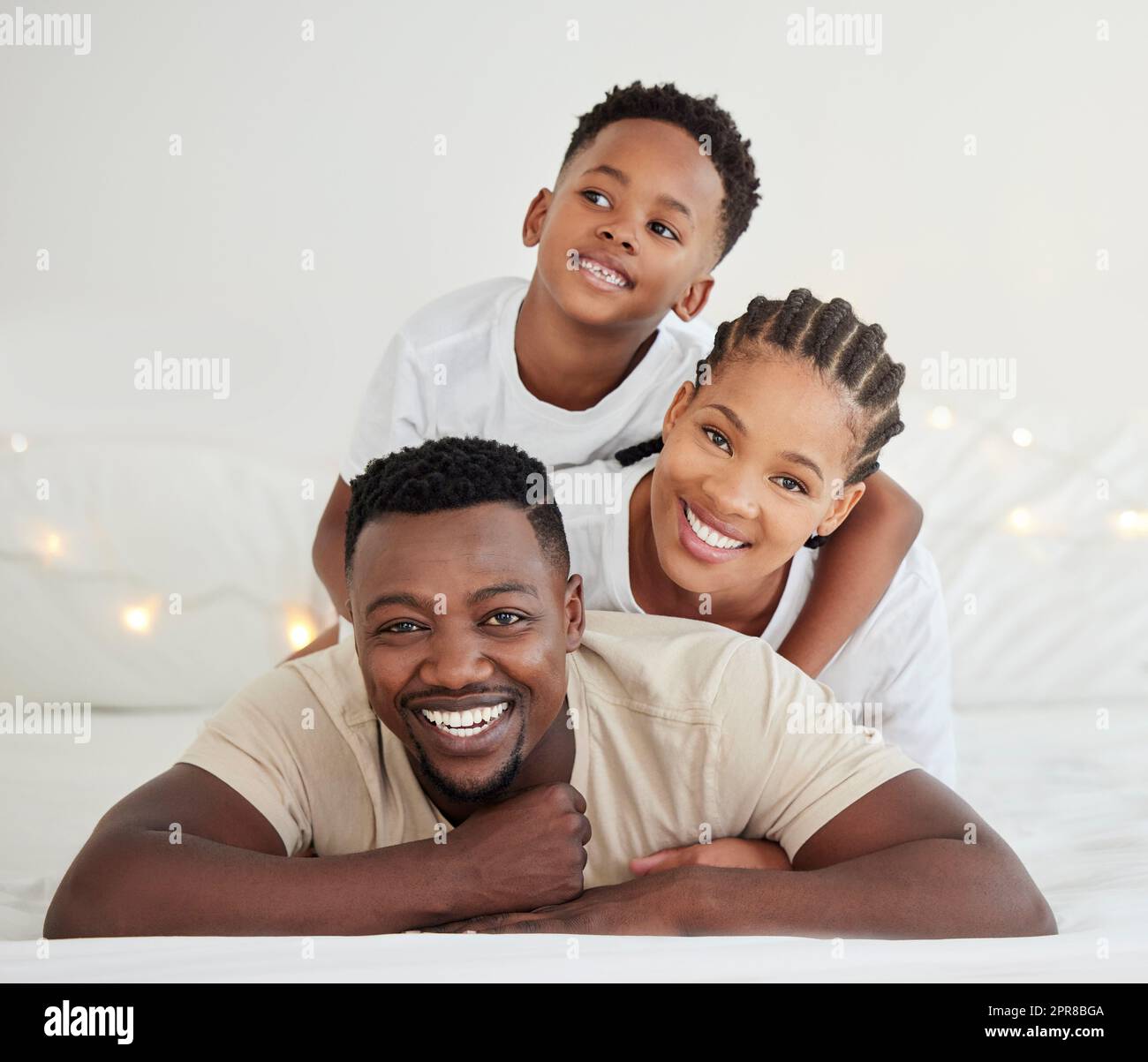 Peace is the beauty of life. parents lying in bed with their son at