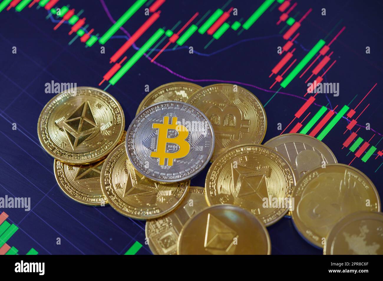 Stack or heap of gold various cryptocurrency coins with candle stick graph  chart and digital background Stock Photo - Alamy