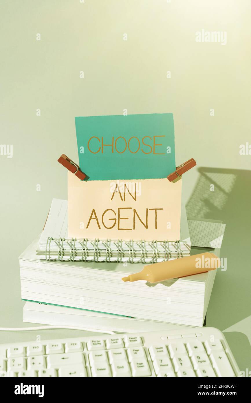 Text showing inspiration Choose An Agent. Internet Concept Choose someone who chooses decisions on behalf of you Important Messages Presented On Piece Of Paper On Desk With Books. Stock Photo