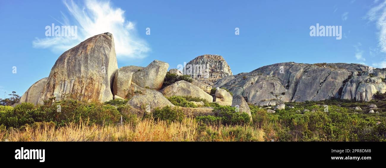 Panorama and landscape view of mountains in Cape Town, South Africa during summer holiday and vacation. Scenic hills, scenery of fresh green flora growing in remote area. Stock Photo