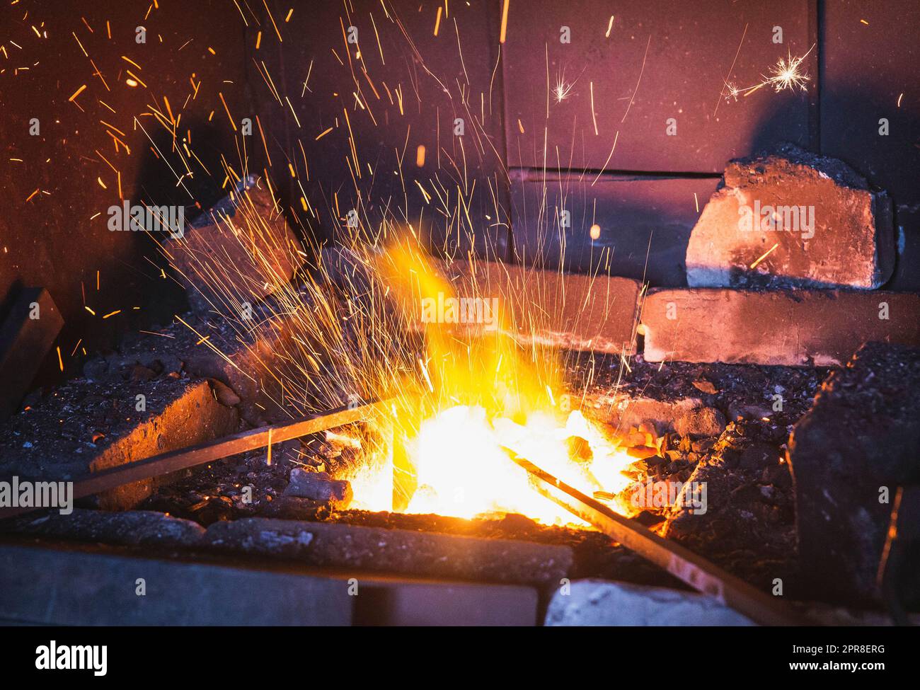 Metal rods are heated in a and sparks crumble Stock Photo Alamy