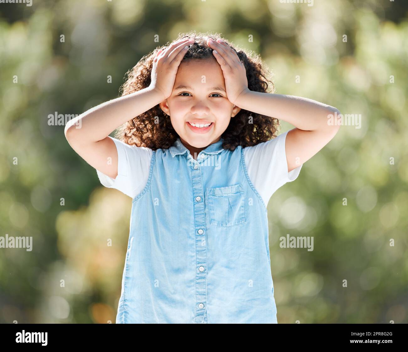 Being little is kind of a big deal. Shot of an adorable little girl standing outside. Stock Photo