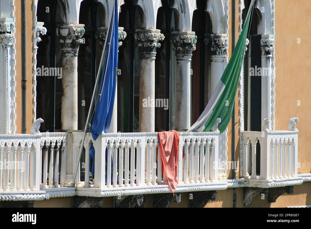 a balcony in Venice decorated with flags Stock Photo